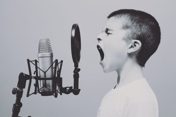 A kid with a microphone: Photo by Jason Rosewell on Unsplash